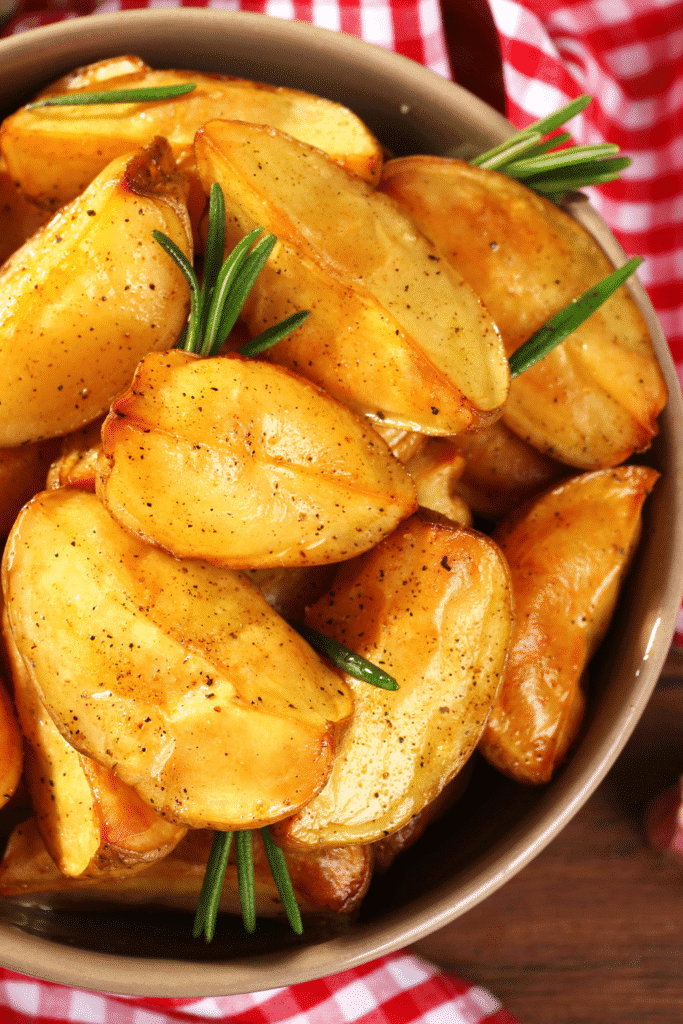 A close-up of a single, perfectly baked potato wedge.